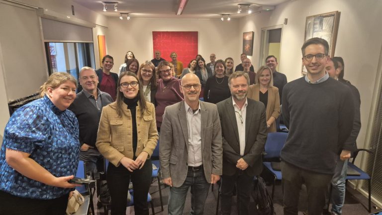 ChallengeEU team at work meeting in Brussels. People are standing in the meeting room.