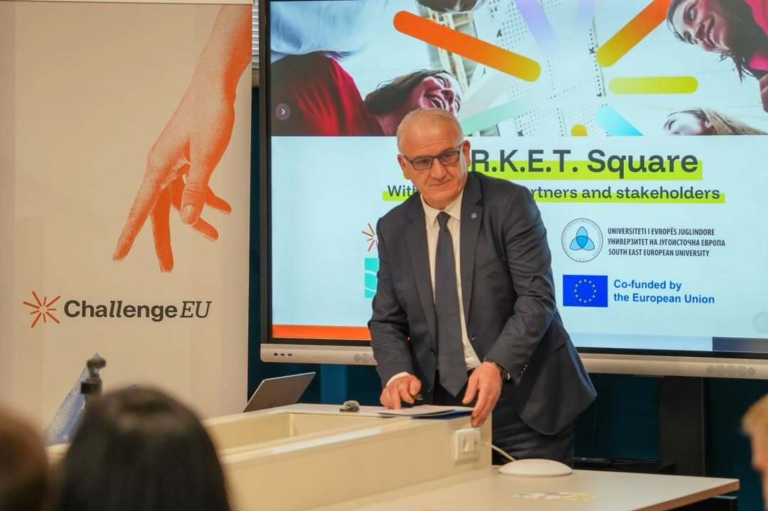 Close view of a presenter at the front; behind him a slide highlights “M.A.R.K.E.T. Square” with ChallengeEU and EU logos