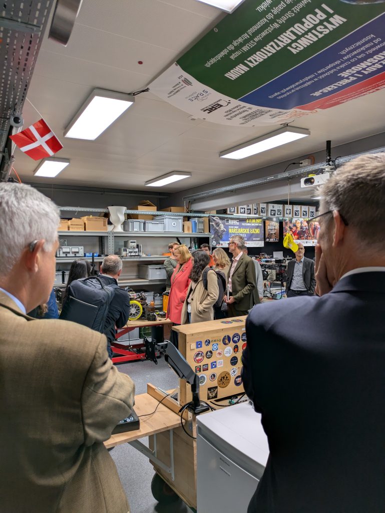Visitors inside a workshop or lab space at FHNW, observing equipment and demonstrations