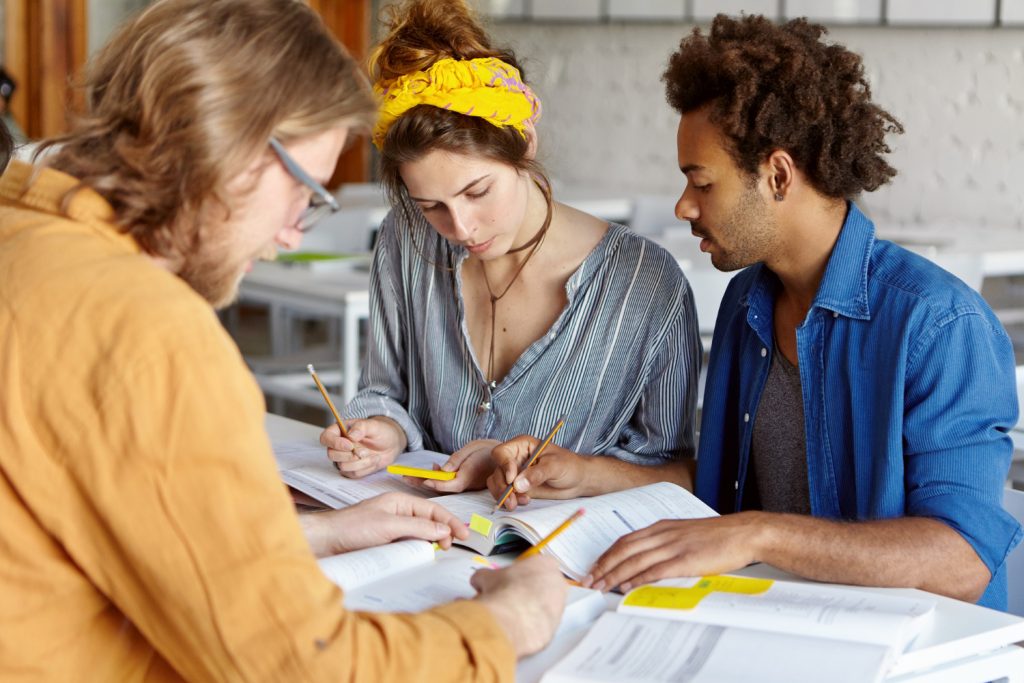 Colleagues working together while sitting in cafe