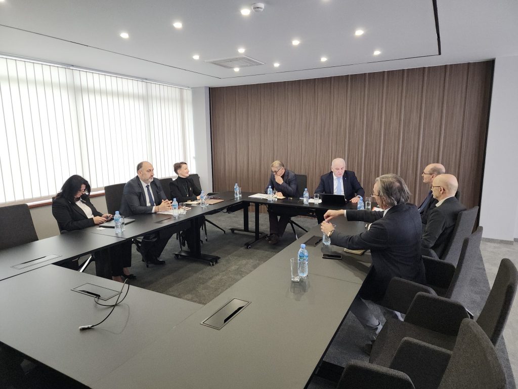 SEEU leadership and representatives from Hochschule Offenburg seated around a conference table in a modern meeting room, discussing collaboration as water bottles and laptops are placed in front of them.