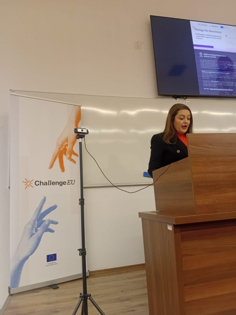 SEEU representative speaking at the podium during the “Orange for Awareness” seminar, with a ChallengeEU banner visible beside the lecturer.