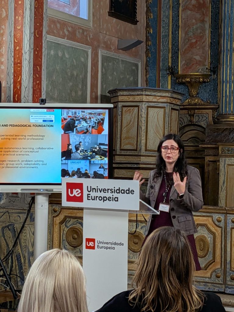 Speaker presenting educational content at a podium in a historic university interior as part of a teaching and learning session.