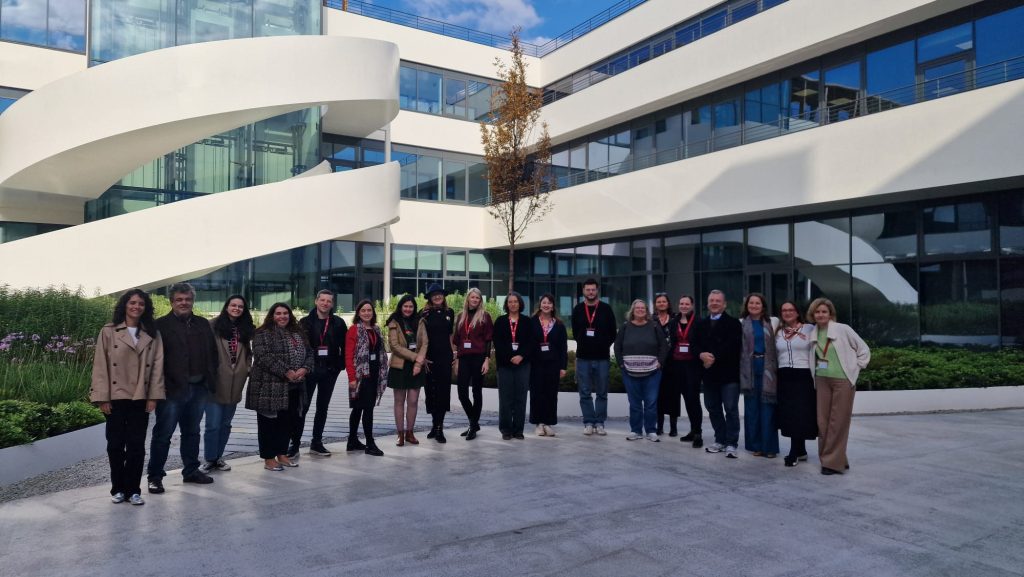 Group photo of participants standing outside a modern university building during a ChallengeEU training event.