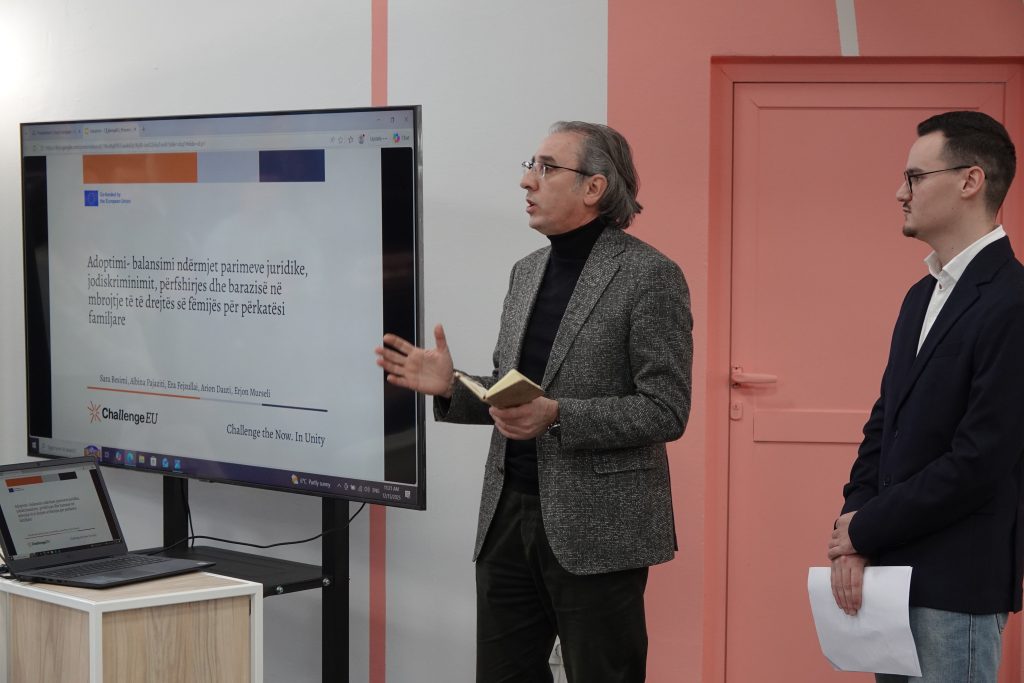 A speaker addresses participants next to a large screen displaying a presentation on adoption law and equality principles, part of the ChallengeEU-branded academic showcase.