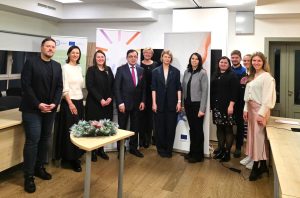 Group photo of eleven participants at a ChallengeEU meeting at LBTU’s Technology and Knowledge Transfer Centre, standing between roll-up banners (including EU/ChallengeEU branding); a small table with a winter wreath and candles is in the foreground