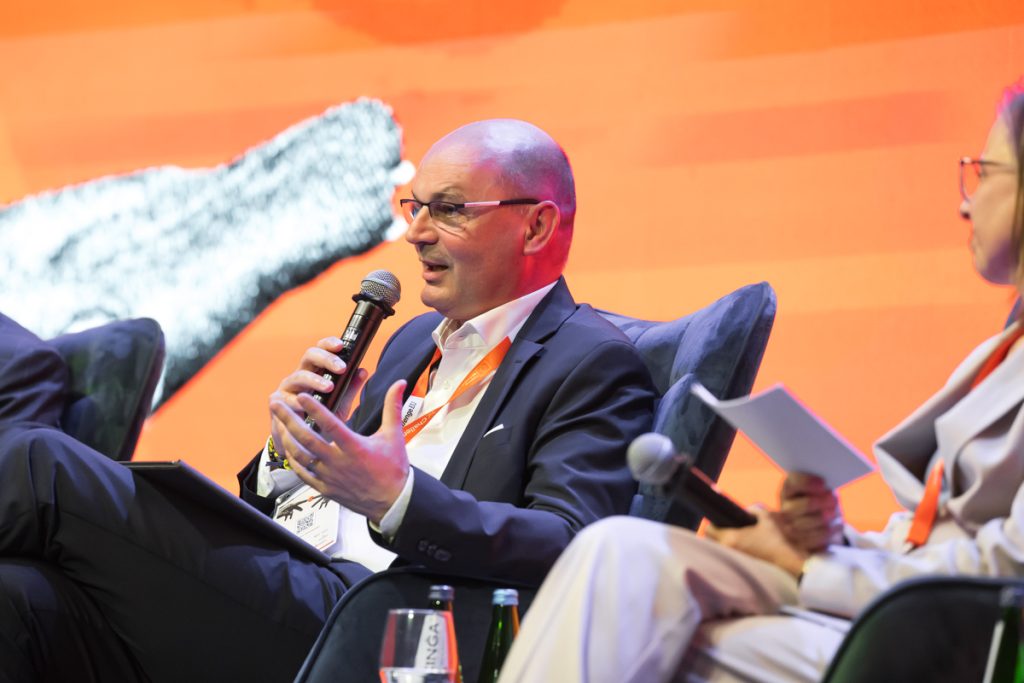 Panel discussion during the ChallengeEU 1st Annual Conference, with speakers seated on stage and one panellist speaking into a microphone