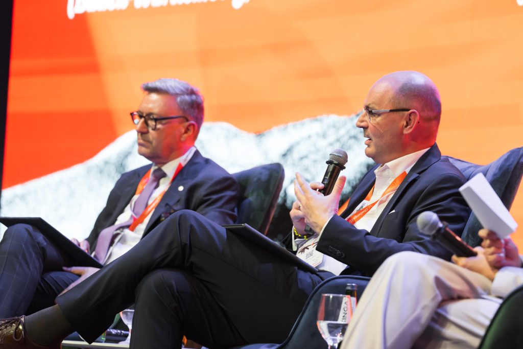 Panel discussion during the ChallengeEU 1st Annual Conference, with speakers seated on stage and one panellist speaking into a microphone