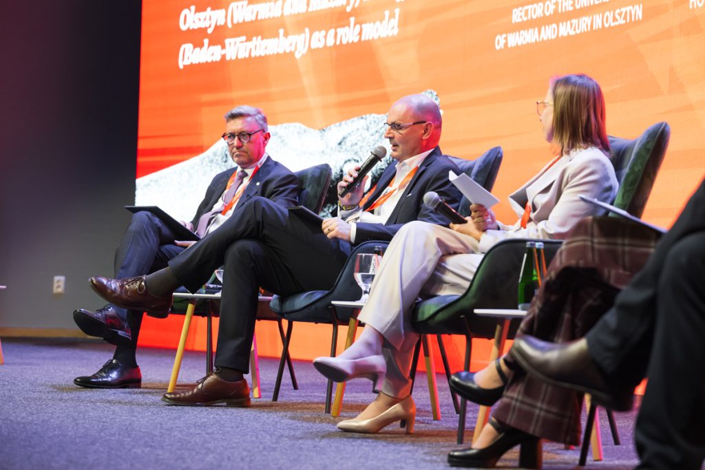 Panel discussion during the ChallengeEU 1st Annual Conference, with speakers seated on stage and one panellist speaking into a microphone