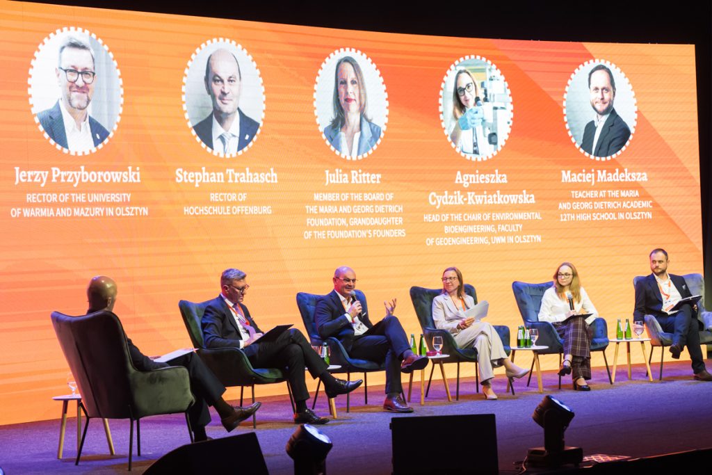 Panel discussion during the ChallengeEU 1st Annual Conference, with speakers seated on stage and one panellist speaking into a microphone