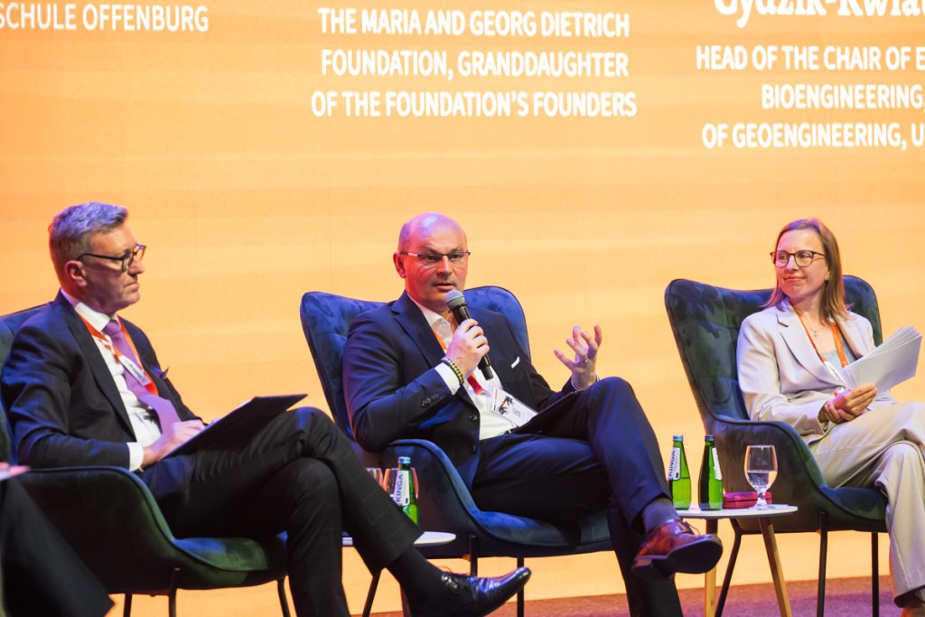 Panel discussion during the ChallengeEU 1st Annual Conference, with speakers seated on stage and one panellist speaking into a microphone