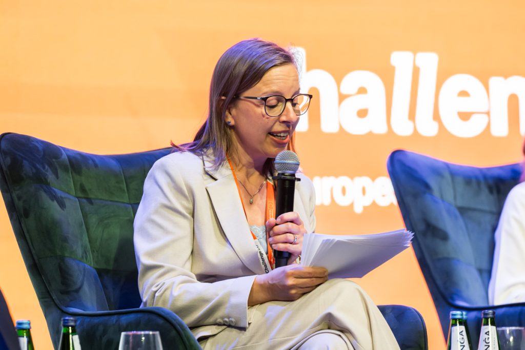 Panel discussion during the ChallengeEU 1st Annual Conference, with speakers seated on stage and one panellist speaking into a microphone