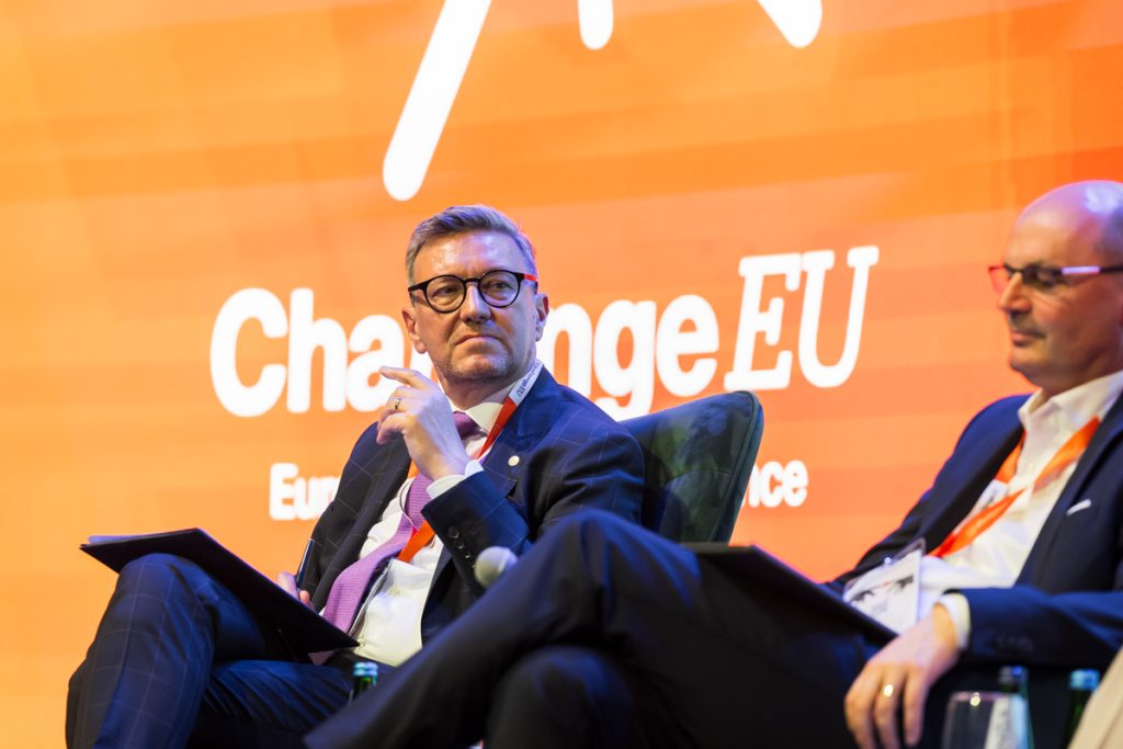 Panel discussion during the ChallengeEU 1st Annual Conference, with speakers seated on stage and one panellist speaking into a microphone