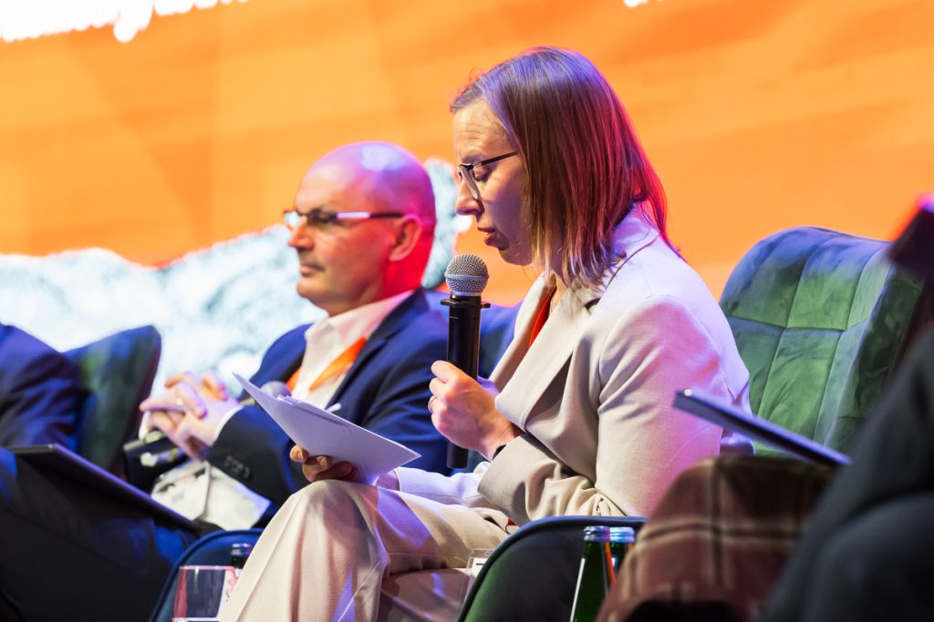 Panel discussion during the ChallengeEU 1st Annual Conference, with speakers seated on stage and one panellist speaking into a microphone