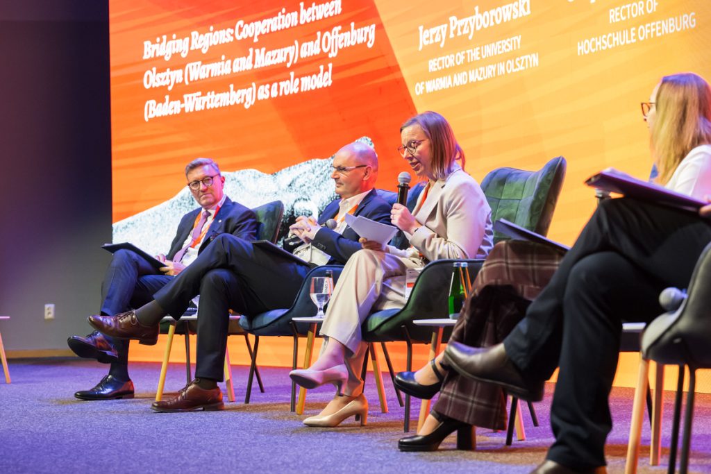 Panel discussion during the ChallengeEU 1st Annual Conference, with speakers seated on stage and one panellist speaking into a microphone