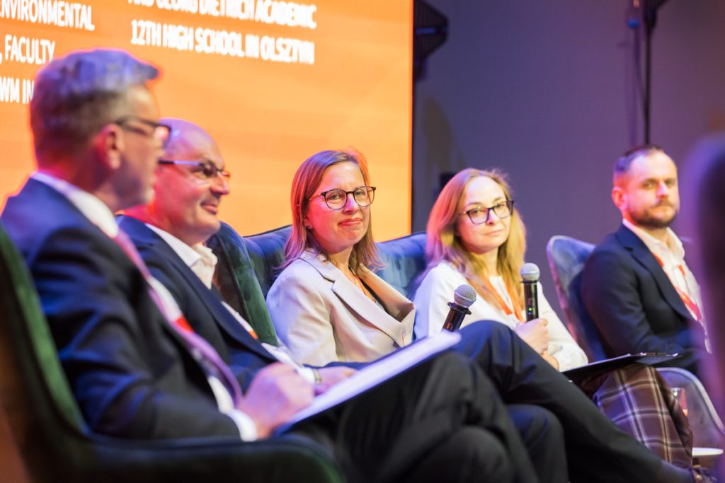 Panel discussion during the ChallengeEU 1st Annual Conference, with speakers seated on stage and one panellist speaking into a microphone
