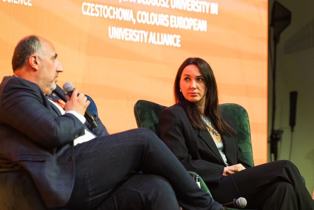 Panel discussion during the ChallengeEU 1st Annual Conference, with speakers seated on stage and one panellist speaking into a microphone