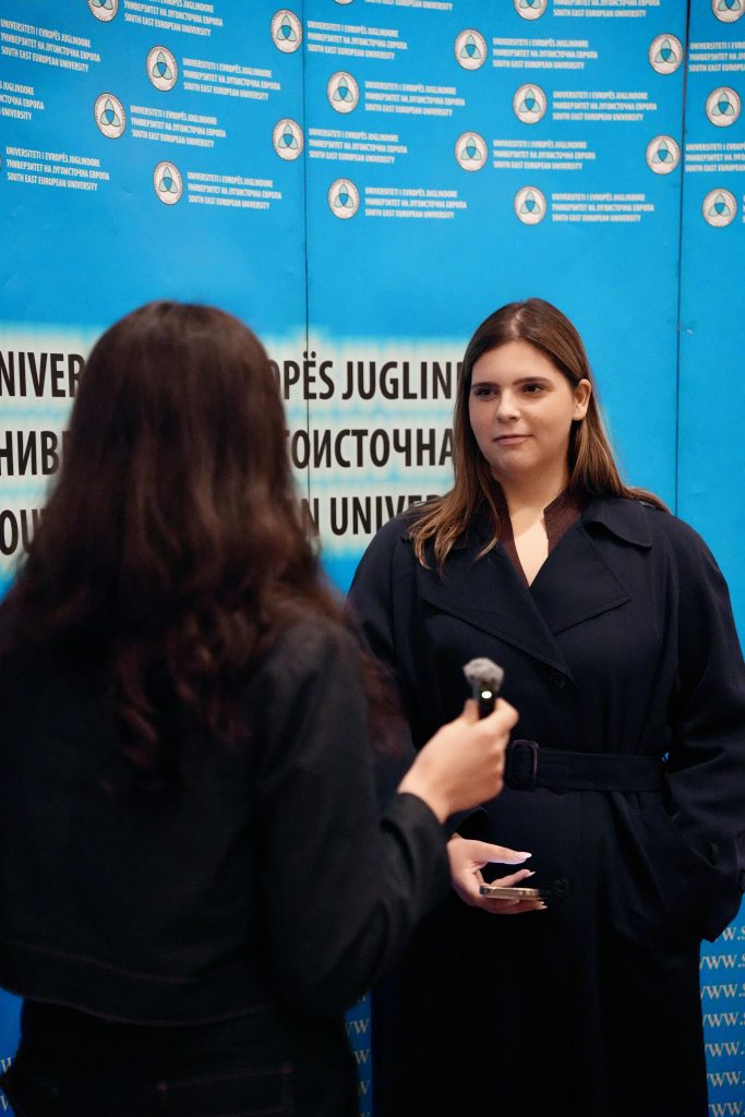 The picture shows two young women that recording an interview in the SEEU's event dedicated to young people's mental health. 
