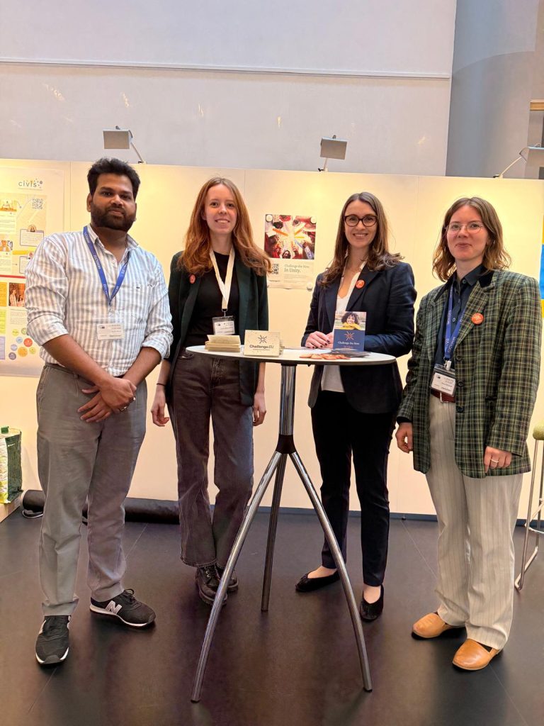 Four ChallengeEU representatives stand by the ChallengeEU stand at the Village of Alliances fair during the European Student Assembly 2026 in Strasbourg.