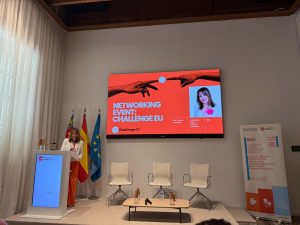 A speaker presents the ChallengeEU Talent Academy during ISCBE 2026, with a presentation slide and conference banner visible on stage.