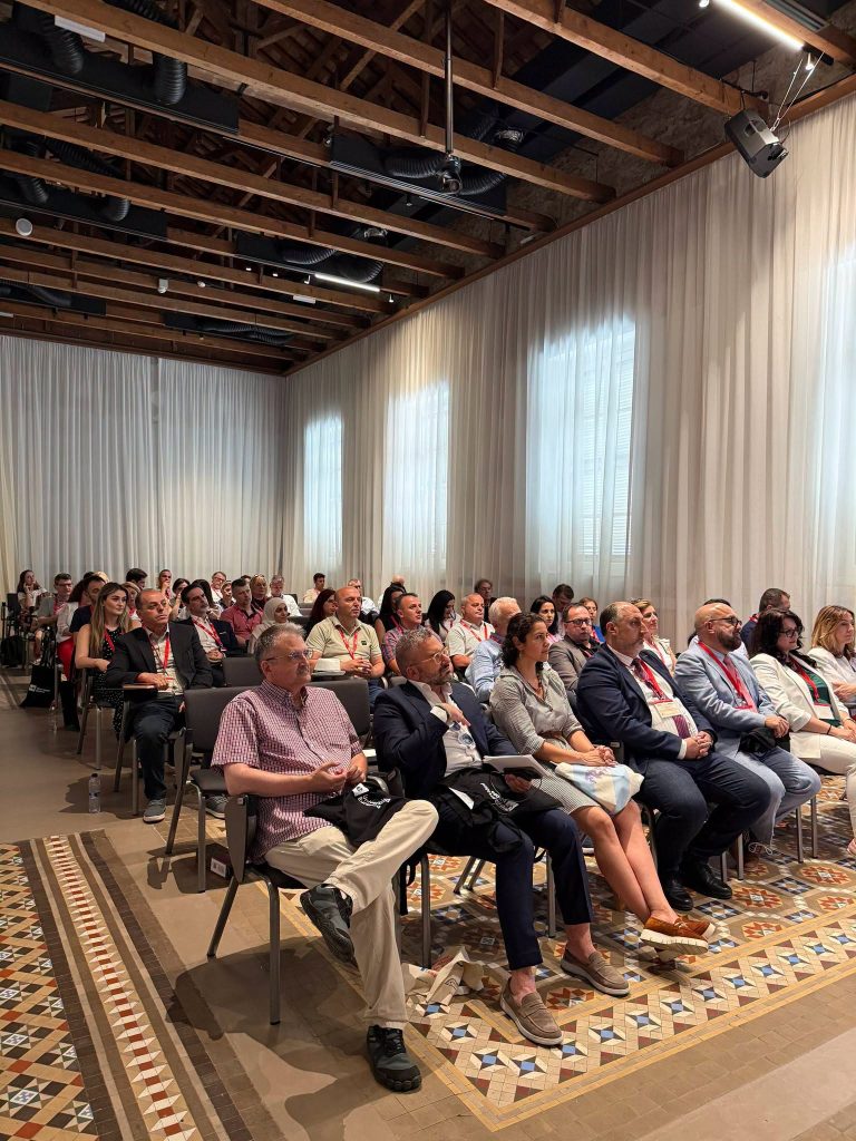 Conference participants seated in a lecture hall during ISCBE 2026, listening to a presentation at Universidad Europea de Valencia.