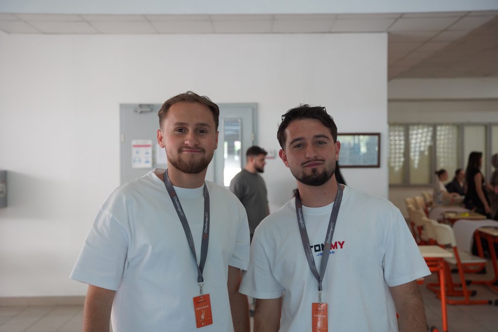 Two hackathon participants pose for a photo in the hall on the SEEU campus.