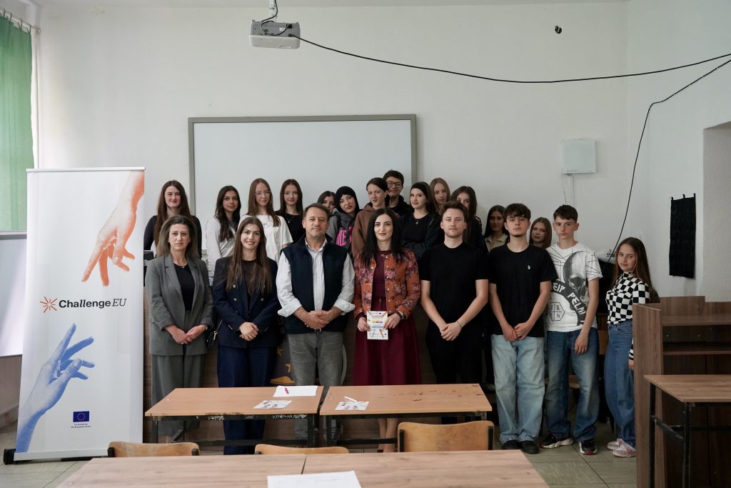 Participants in the ChallengeEU campaign during a group photo in a classroom. A ChallengeEU roll-up banner is visible next to the students and organisers.