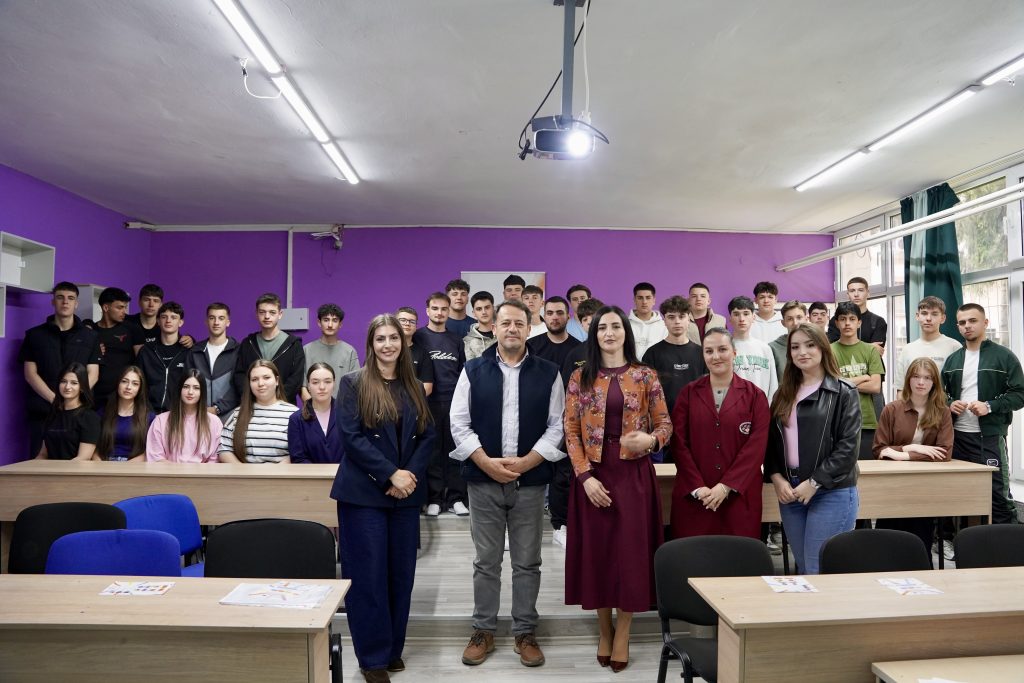 Participants in the ChallengeEU campaign during a group photo in a classroom. A ChallengeEU roll-up banner is visible next to the students and organisers.