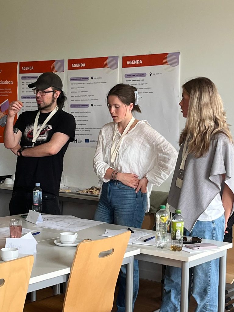 Participants stand and discuss ideas during an interactive workshop exercise.