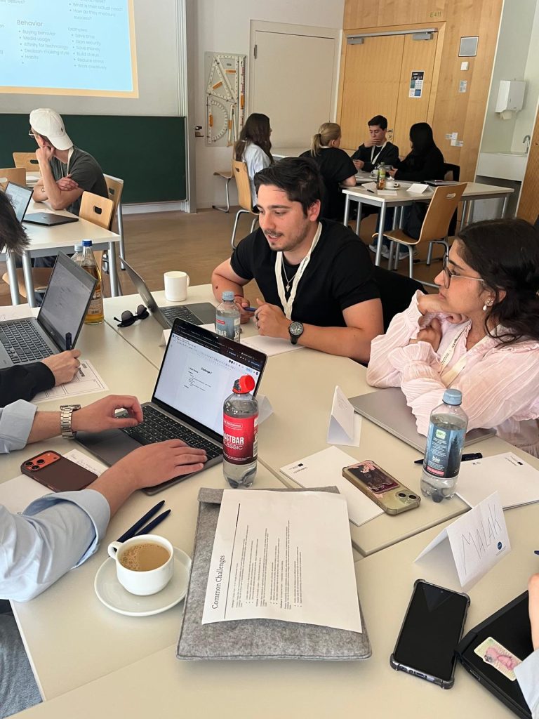 Students sit together at a table during a group work session.