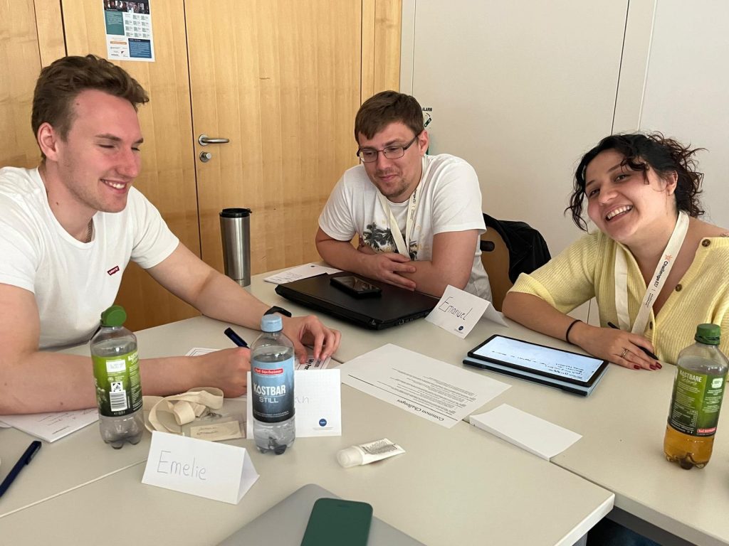 Students sit together at a table during a group work session.