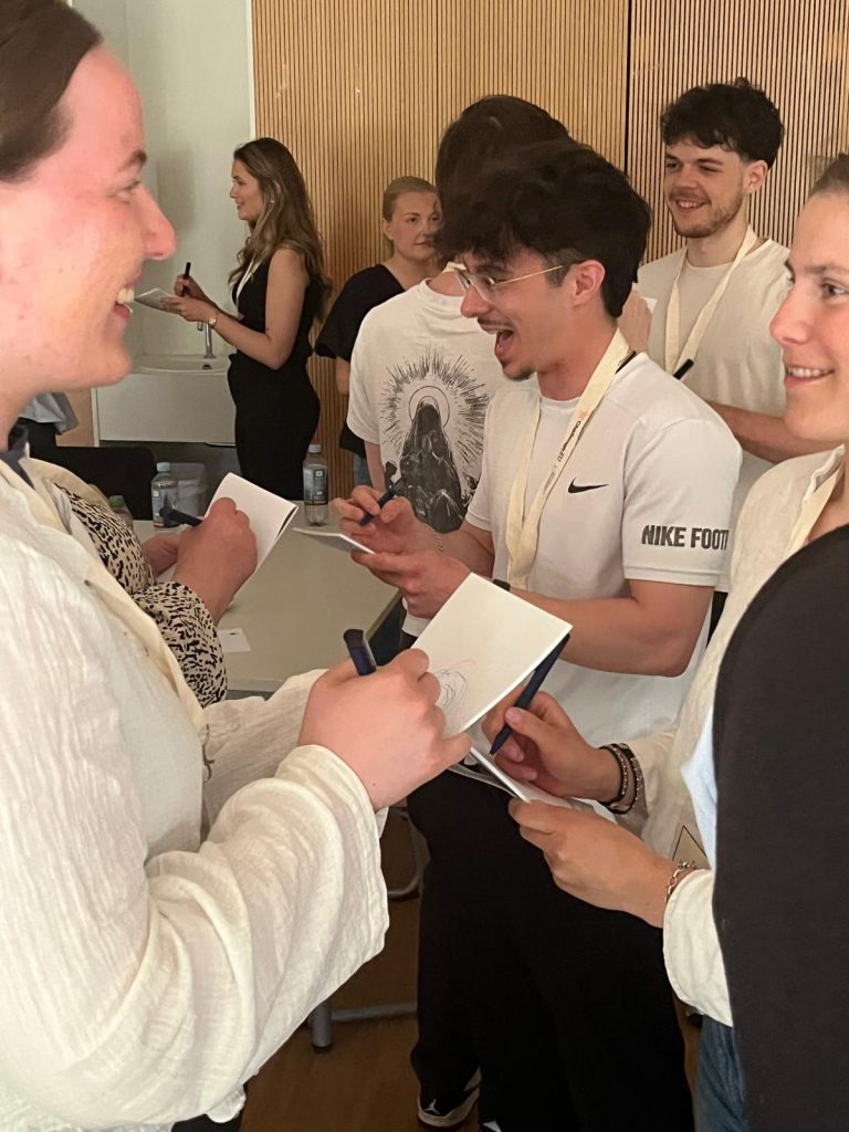 Students exchange ideas and take notes during an interactive workshop activity.