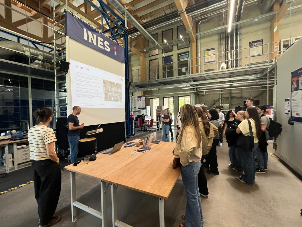 Students visit a laboratory space and listen to a presentation about sustainable energy systems.