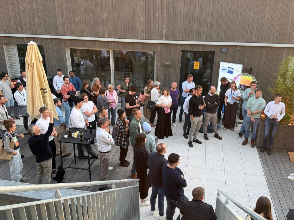 Participants gather in an outdoor courtyard during a networking event.