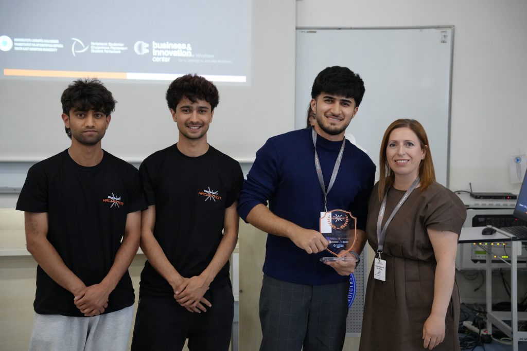 A student team and organiser pose with the Best Social Idea award at the ChallengeEU Hackathon.