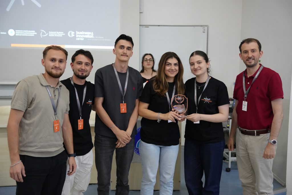 A student team and mentor pose with the Best Technical Idea award at the ChallengeEU Hackathon.