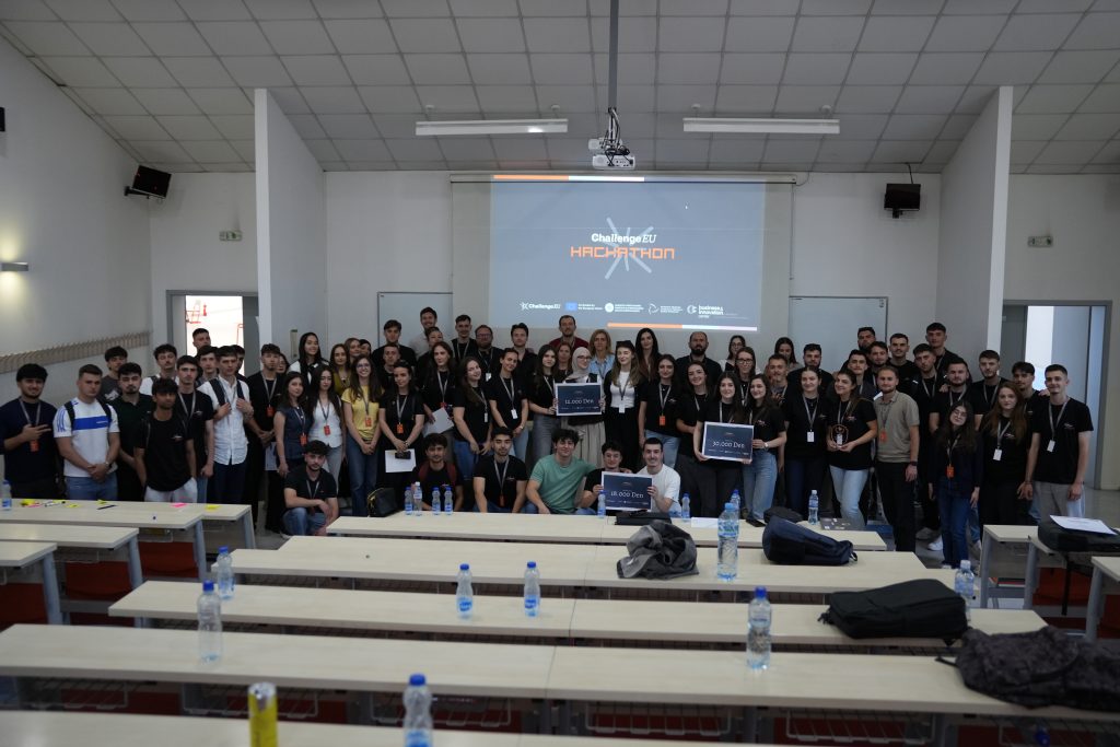 Participants and organisers of the ChallengeEU Hackathon pose together in a lecture room at South East European University, with the hackathon presentation displayed on the screen behind them.