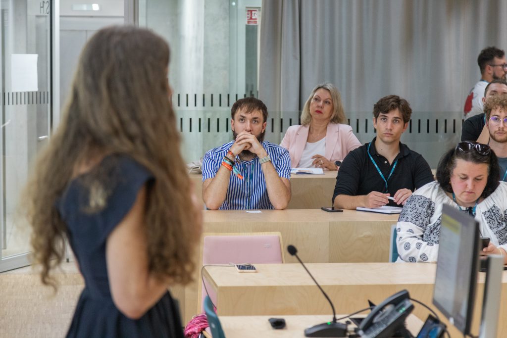 Participants take notes and listen during a discussion session at the EUSAF Conference 2026 in Warsaw.