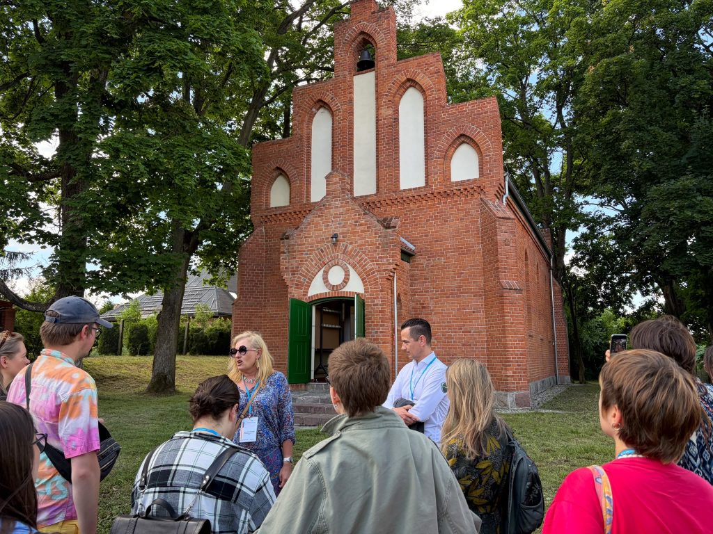 Participants of the Traces in the Landscape Summer School explore a historic church in Stawiguda.
