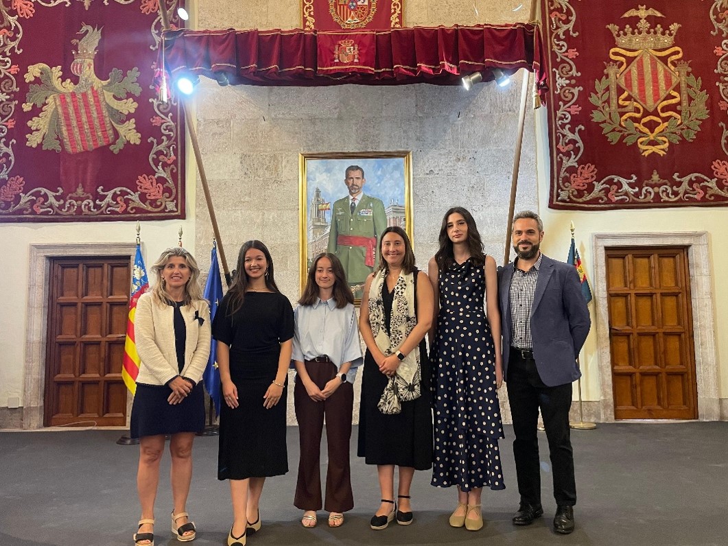 Six people pose for a photo