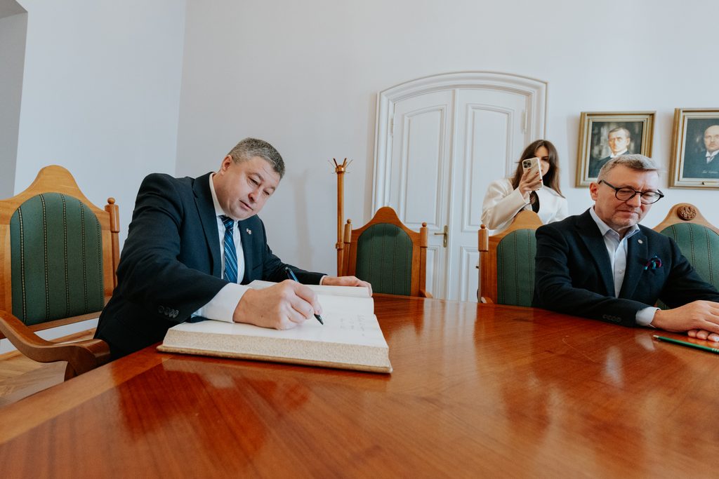 Meeting participants sign a Memorandum of Understanding.