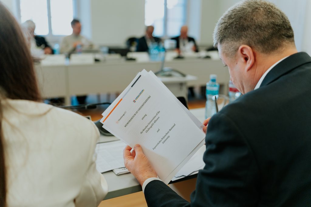 Meeting participants sign a Memorandum of Understanding.