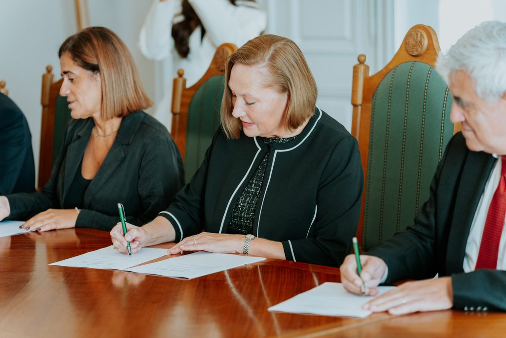 Meeting participants sign a Memorandum of Understanding.