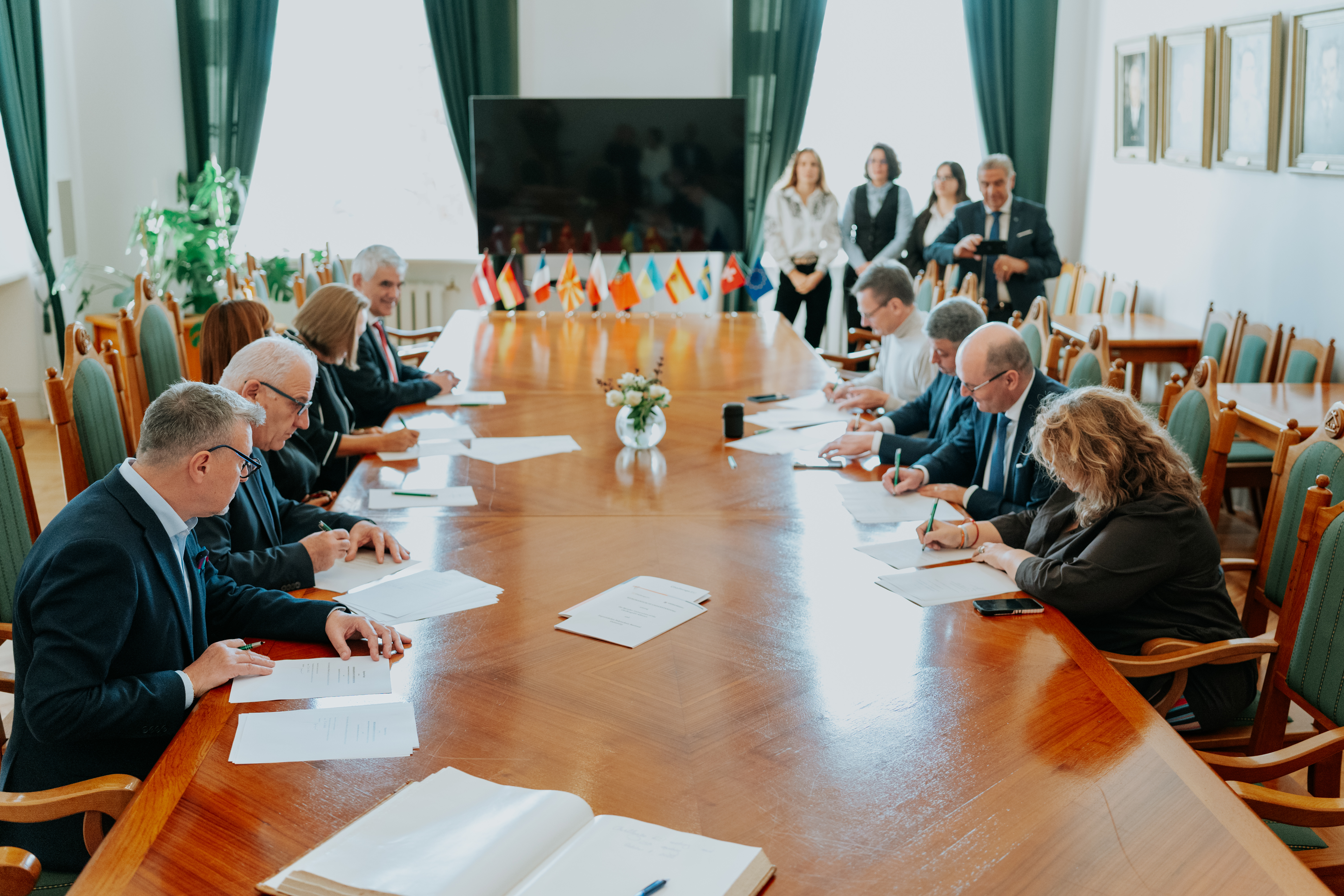 Meeting participants sign a Memorandum of Understanding.
